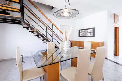 a dining room with a glass table and white chairs at Marys House 2 in Rhodes Town