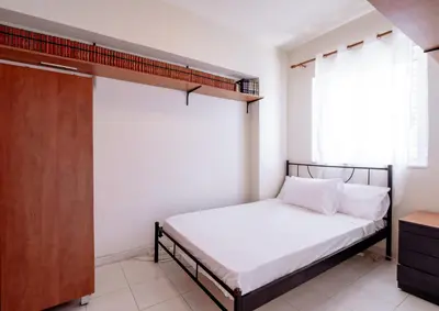 a small bedroom with a bed and a window at Marys House 2 in Rhodes Town
