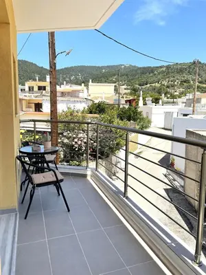a balcony with a table and a view at Vasilias House in Apóllona