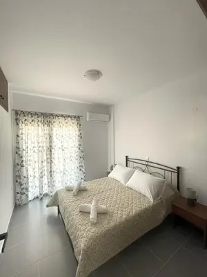 a bedroom with a bed with two towels on it at Vasilias House in Apóllona