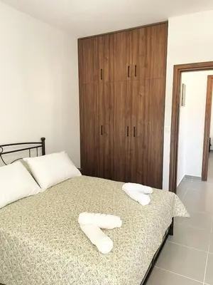 a bedroom with a bed with two towels on it at Vasilias House in Apóllona