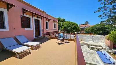 a patio with chairs and tables on a house at Old Town Pearl in Rhodes Town
