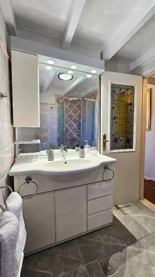 a bathroom with a large white sink and a mirror at Old Town Pearl in Rhodes Town
