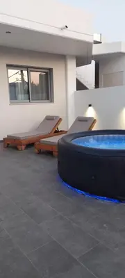 a room with a large hot tub in a building at Castalia Naiades Suites in Ialyssos