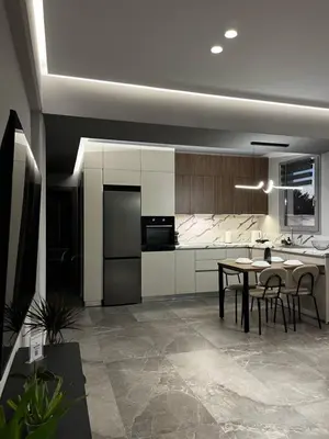 a kitchen and dining room with a table and chairs at Castalia Naiades Suites in Ialyssos