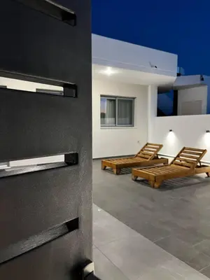 a room with two lounge chairs and a room with at Castalia Naiades Suites in Ialyssos