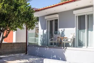 a house with a porch with chairs and a table at Aelia House in Kalithies