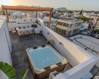 a hot tub on the balcony of a house at Celestial Acropolis View in Archangelos