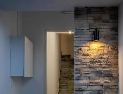 a room with a stone wall with a sign on it at Celestial Acropolis View in Archangelos