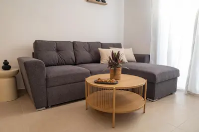 a living room with a couch and a table at Celestial Acropolis View in Archangelos