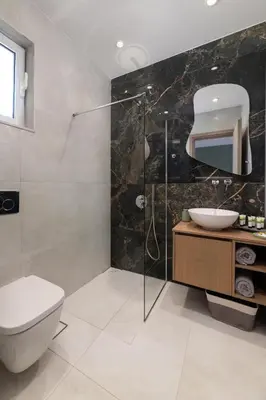 a bathroom with a toilet and a sink and a shower at Elysian Luxury Residence in Vrachonisída touArchangélou