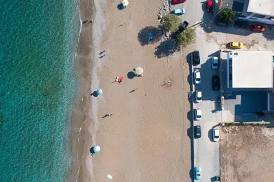 an overhead view of a beach with parked cars at Elysian Luxury Residence in Vrachonisída touArchangélou