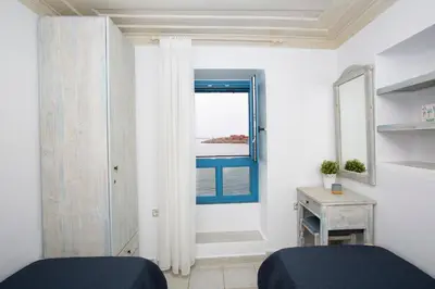 a bedroom with a window with a view of the ocean at Villa Annouska in Halki