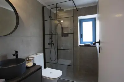 a bathroom with a shower and a toilet and a sink at Villa Annouska in Halki