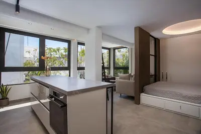 a bedroom with a bed and a kitchen with a counter at The Keep38 in Rhodes Town