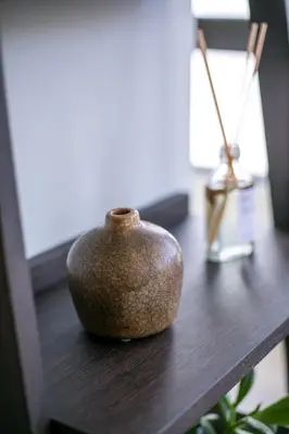 a brown vase sitting on a wooden table at The Keep38 in Rhodes Town