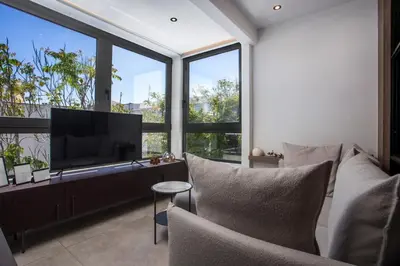 a living room with a tv and large windows at The Keep38 in Rhodes Town