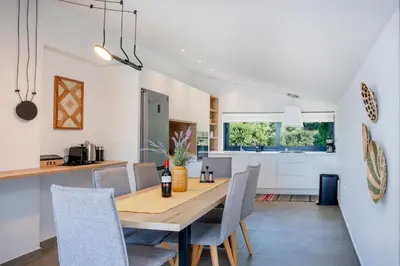 a dining room and kitchen with a wooden table and chairs at The Gem Loft City Apartment in Rhodes Town
