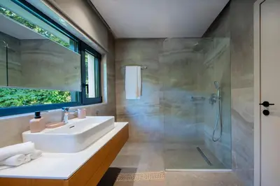 a bathroom with a sink and a shower at The Gem Loft City Apartment in Rhodes Town