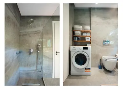 a bathroom with a shower and a washing machine at The Gem Loft City Apartment in Rhodes Town