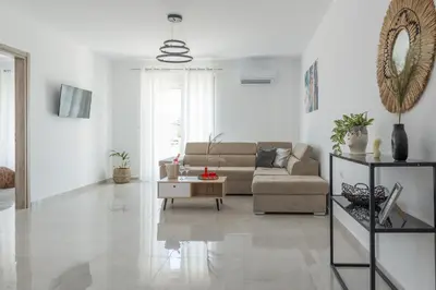 a living room with a couch and a table at Katerina family Apartment in Archangelos