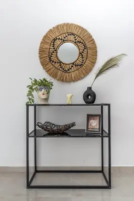 a shelf with a mirror and plants on it at Katerina family Apartment in Archangelos