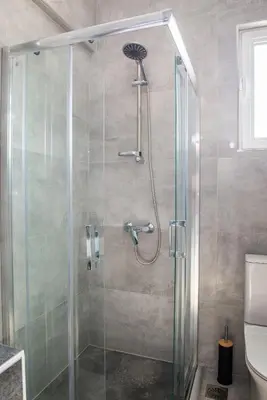 a shower with a glass door in a bathroom at Katerina family Apartment in Archangelos