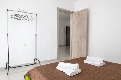 a bedroom with a bed with two pillows on it at Katerina family Apartment in Archangelos