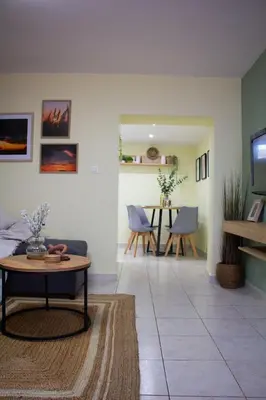 a living room with a couch and a table at The 20A Terminal Stay N Fly in Paradeísion