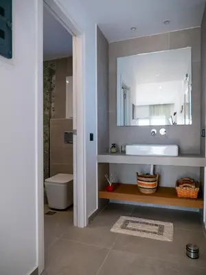 a bathroom with a sink and a toilet at Zen Beach Suite Faliraki in Faliraki