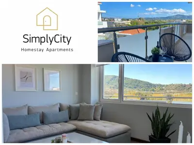 a living room with a couch and a window at SimplyCity Homestay Apartment 2 in Kremasti
