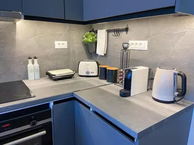 a kitchen with a counter top with appliances on it at SimplyCity Homestay Apartment 2 in Kremasti