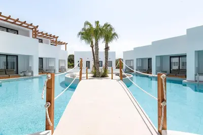 a swimming pool with a walkway in a resort at Martini Boutique Resort in Ialyssos