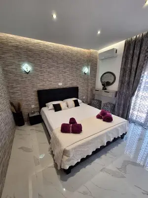 a bedroom with a large bed with two towels on it at EFReMIAS PLACE in Rhodes Town
