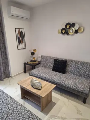a living room with a couch and a table at EFReMIAS PLACE in Rhodes Town