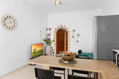 a dining room with a table and a clock at Malona Nostalgia in Malona Village