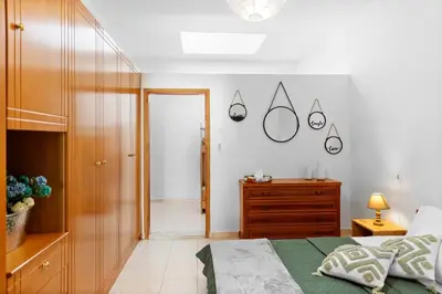 a bedroom with a bed and a dresser and a mirror at Malona Nostalgia in Malona Village