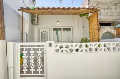 a white gate in front of a house at Malona Nostalgia in Malona Village