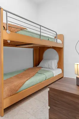 two bunk beds in a room with a desk at Malona Nostalgia in Malona Village
