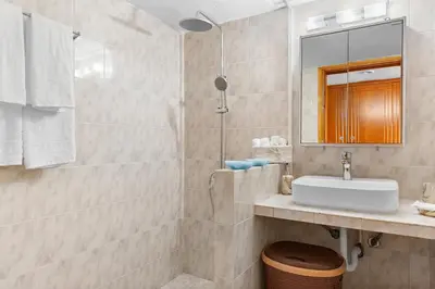 a bathroom with a sink and a mirror at Malona Nostalgia in Malona Village
