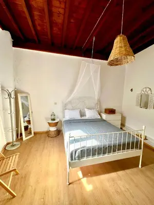 a bedroom with a bed and a wooden floor at Rafaela suite old town in Rhodes Town