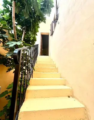 a stairway leading up to a building with a door at Rafaela suite old town in Rhodes Town