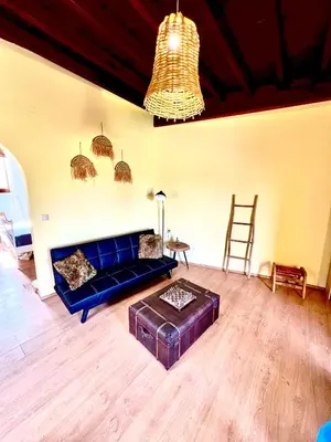 a living room with a blue couch and a table at Rafaela suite old town in Rhodes Town