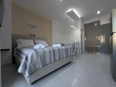a bedroom with a bed with towels on it at Pixel Palace in Rhodes Town