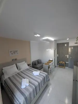 a bedroom with a bed and a living room at Pixel Palace in Rhodes Town