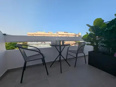 a table and chairs on a balcony with a view at Pixel Palace in Rhodes Town