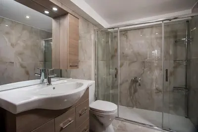 a bathroom with a toilet and a sink and a shower at Zafora Garden in Koskinou