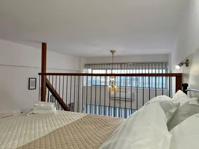 a bedroom with a bed and a balcony at Polikseni Apartment Orfanidou in Rhodes Town