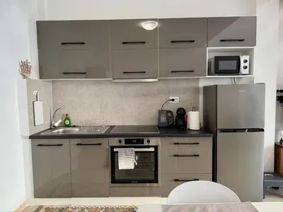 a kitchen with a sink and a refrigerator at Polikseni Apartment Orfanidou in Rhodes Town