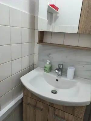 a bathroom with a white sink and a mirror at Polikseni Apartment Orfanidou in Rhodes Town